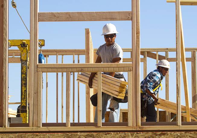 Carpenters frame a house at a KB Homes project at Inspirada in Henderson Tuesday, June 3, 2014. A number of formerly stalled or financially troubled master-planned communities are now back in business, with developers building and selling homes.