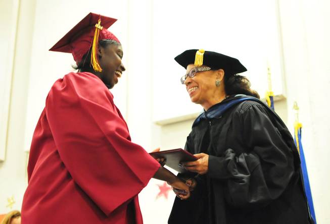 Simone Taylor, 25, receives her high school diploma from School Board Vice President Linda Young during a graduation ceremony at the Florence McClure Women's Correctional Center on Tuesday, June 3, 2014. More than 70 female inmates at Nevada's only women's prison earned their high school diplomas, GEDs and vocational certificates this year from the Clark County School District's adult education program.