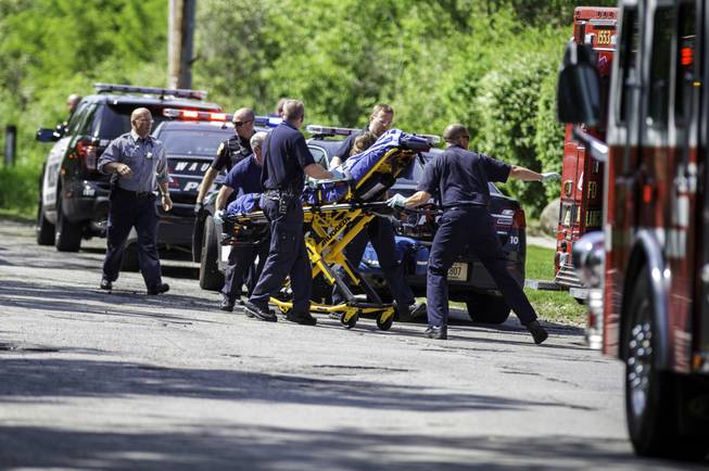 In this Saturday, May 31, 2014, photo, rescue workers take a stabbing victim to the ambulance in Waukesha, Wis. Prosecutors say two 12-year-old southeastern Wisconsin girls stabbed their 12-year-old friend nearly to death in the woods to please a mythological creature they learned about online.