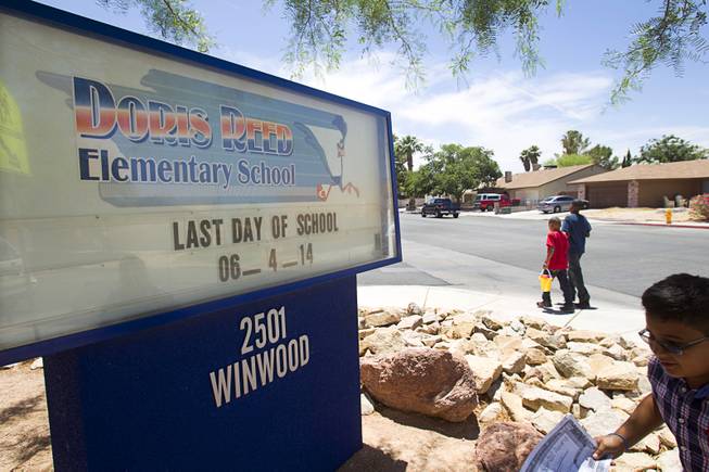 Children leave Reed Elementary School on the last day of school Wednesday, June 4, 2014. 