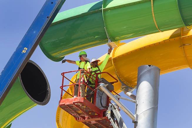 Workers line up the final piece of the "Breaker 1-9" water slide at the Cowabunga Bay water park in Henderson Thursday, June 5, 2014. Developers announced today that the water park will open July 4. The park includes a 32,000-square-foot wave pool, water slides and a 1,200-foot-long lazy river. 