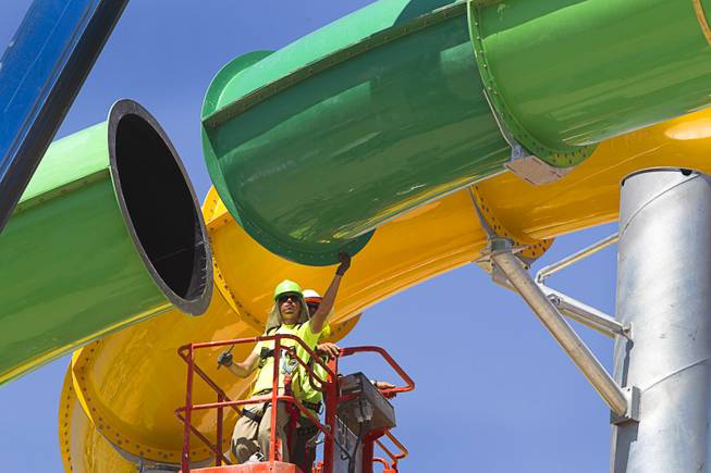 Workers line up the final piece of the "Breaker 1-9" water slide at the Cowabunga Bay water park in Henderson Thursday, June 5, 2014. Developers announced that the water park will open July 4. The park includes a 32,000-square-foot wave pool, water slides and a 1,200-foot-long lazy river.