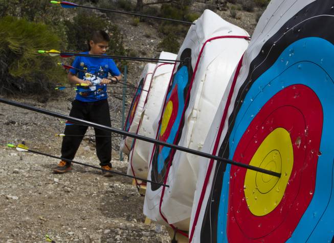 A camper retrieves his arrows at an archery lesson during Camp Vegas at Pitosi Pines sponsored by the Nevada Diabetes Association Tuesday, April 15, 2014.