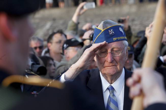 World War II veteran of the U.S. 29th Infantry Division, Morley Piper, 90, Mass., salutes during a D-Day commemoration, on Omaha Beach in Vierville sur Mer, western France , Friday June 6, 2014. Veterans and Normandy residents are paying tribute to the thousands who gave their lives in the D-Day invasion of Nazi-occupied France 70 years ago.