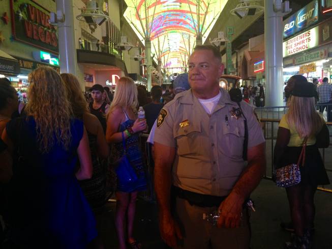 Metro Police Detective R. Bass stands at the 4th Street entrance to the Fremont Street Experience, where heavy security and police were employed to maintain watch over an expected crowd of some 40,000 people.