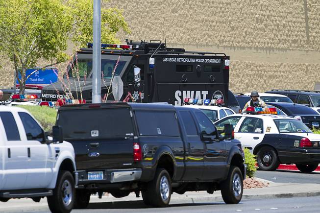 A Metro Police SWAT vehicle is shown outside a Wal-Mart on Nellis Boulevard Sunday, June 8, 2014. Two suspects shot two Metro Police officers in a nearby pizza shop then fled to the Wal-Mart where they shot and killed another person, police said. Both officers died of their injuries.