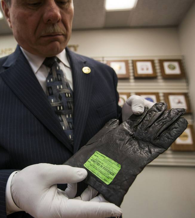 In this May 30, 2014, photo, Los Angeles County District Attorney senior investigator John Calicchio shows a glove used as evidence in the O.J. Simpson murder case, in the D.A's office in Los Angeles. After Simpson was acquitted of killing his ex-wife, Nicole Brown Simpson, and her friend, Ronald Goldman, the LAPD made significant changes in the scientific investigation division.