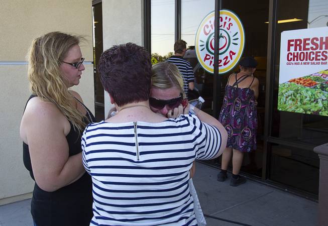 Metro Police dispatchers, left to right, Ashley Walter, Jennifer Pinjuv-Webb, and Kenna Scherado console each other in front of CiCi's Pizza, where two Metro Police officers were killed, during a community vigil Monday,, Nevada June 9, 2014. Police officers Alyn Beck, 41, and Igor Soldo, 31, were ambushed and killed in the restaurant while they were eating lunch on June 8.