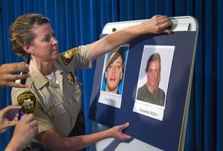 Metro Police Office Laura Meltzer posts photos during a news conference at Metro Police headquarters Monday, June 9, 2014.