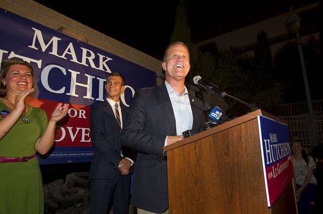 Mark Hutchison, Republican candidate for Lt. Governor, gives a victory speech during an primary election night party at Dom Demarco's Pizzeria Tuesday, June 10, 2014. Also on stage is his daughter Whitney and his son Logan.