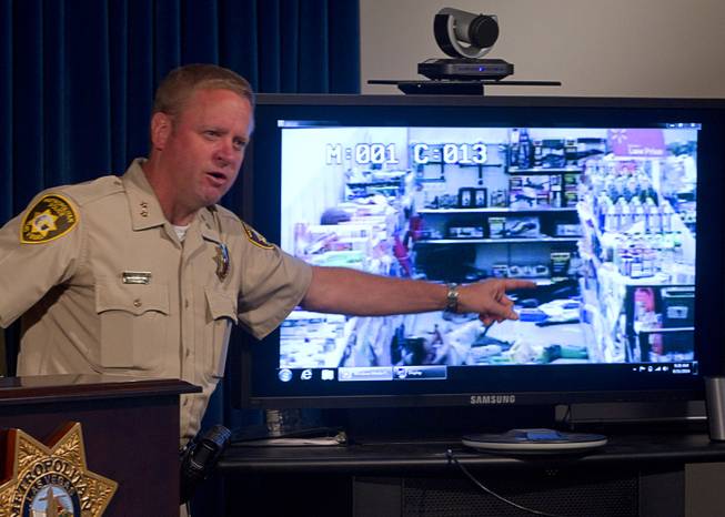 Assistant Sheriff Kevin McMahill points to Wal-Mart store surveillance video of shooting suspects during a news conference at Metro Police headquarters Wednesday, June 11, 2014. Police provided new details on Sunday's shooting that resulted in five deaths, including two police officers and a civilian.