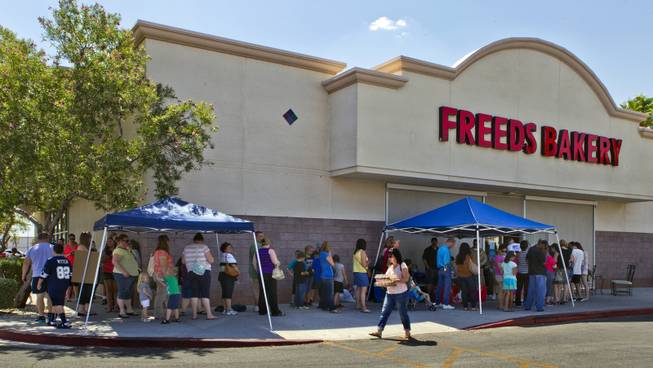 Customers wait patiently in line at Freed's Bakery of Las Vegas to donate and purchase some 35,000 cupcakes for $1 each with the proceeds going to aid the families of slain Metro Police officers Metro officers Alyn Beck and Igor Soldo on Wednesday, June 11, 2014.