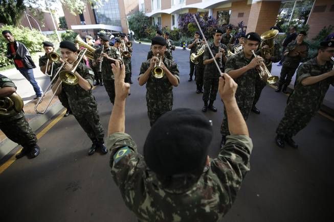 Brazilian military band performs South Korea's national anthem before the national soccer team's arrival at the team hotel in Foz do Iguacu, Brazil, Wednesday, June 11, 2014. South Korea play in group H of the 2014 soccer World Cup.