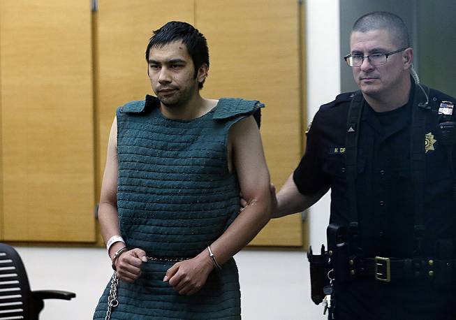 Shooting suspect Aaron Ybarra, left, is led in chains to a court hearing at a King County Jail courtroom Friday, June 6, 2014, in Seattle. Ybarra was arrested in the killing of a 19-year-old student and wounding of two other young people Thursday at Seattle Pacific University. 
