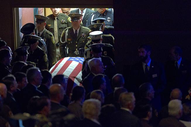 The flag-draped casket of Metro Police Officer Igor Soldo is brought into church during funeral services at Canyon Ridge Church on Thursday, June 12, 2014. Soldo and Metro Police Officer Alyn Beck where ambushed and killed Sunday, June 8.