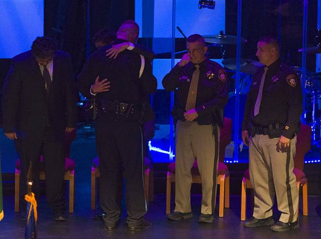 Robert Soldo, the older brother of Metro Police officer Igor Soldo, gets a hug from his brother's friends, after speaking at his brother's funeral at Canyon Ridge Church Thursday, June 12, 2014. Igor Soldo and Metro Police Officer Alyn Beck where ambushed and killed by Jerad and Amanda Miller while eating lunch on Sunday, June 8.