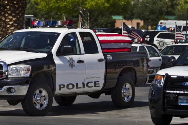 The flag-draped coffin of slain Metro Officer Igor Soldo departs from the Palm Mortuary to the Canyon Ridge Church service on Thursday, June 12, 2014.