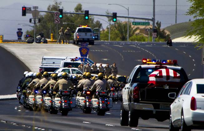 Metro Police Motorcycle Officers and other department officers lead a funeral procession and flag-draped coffin for slain Metro Officer Igor Soldo as it departs from the Palm Mortuary to the Canyon Ridge Church service on Thursday, June 12, 2014.