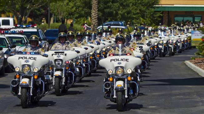 Metro Police Motorcycle Officers lead a funeral procession for slain Metro Officer Igor Soldo as it departs from Palm Mortuary to the Canyon Ridge Church service Thursday, June 12, 2014.
