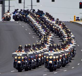 Metro Motorcycle Officers are joined by those from other area departments as they lead the body of slain Metro Officer Igor Soldo to the Palm Mortuary for funeral services on Thursday, June 12, 2014.