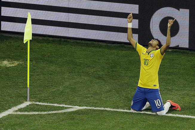 Brazil's Neymar celebrates scoring his side's second goal during the group A World Cup soccer match between Brazil and Croatia, the opening game of the tournament, in Itaquerao Stadium in Sao Paulo, Brazil, on Thursday, June 12, 2014. 