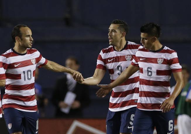 The United States' Landon Donovan (10) congratulates teammate Herculez Gomez, center, after Gomez scored a goal on Guatemala as teammate Joe Corona, right, watches in the first half during an international friendly soccer match Friday, July 5, 2013, in San Diego. 