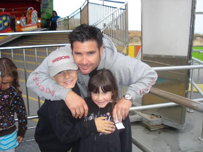 This undated image provided Tuesday April 5, 2011, by John Stow shows Bryan Stow holding his 12-year-old son and 8-year-old daughter.