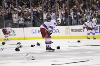 New York Rangers left wing Benoit Pouliot looks down after losing to the Los Angeles Kings during overtime in Game 5 of the NHL Stanley Cup Final series Friday, June 13, 2014, in Los Angeles. (AP Photo/Gregory Bull)
