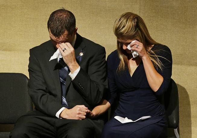 Joseph Beck, left, and Elizabeth Krmpotich wipe tears from their eyes during a memorial service for their brother Las Vegas Metropolitan Police Officer Alyn Beck at The Smith Center for the Performing Arts Saturday, June 14, 2014 in Las Vegas. Two suspects shot and killed Beck, 41, and fellow police officer Igor Soldo, 31, in an ambush at a Las Vegas restaurant Sunday, June 8, 2014, before fatally shooting a third person inside a nearby Wal-Mart, authorities said.