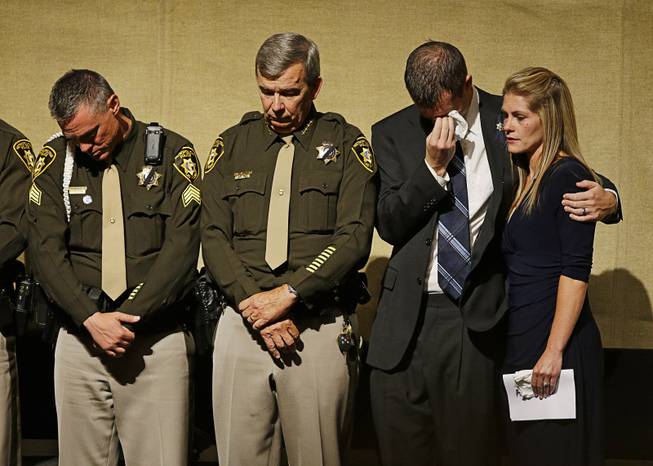From left, Sgt. Jimmy Oaks, Clark County Sheriff Doug Gillespie, Joseph Beck and Elizabeth Krmpotich attend a memorial service for Las Vegas Metropolitan Police Officer Alyn Beck at The Smith Center for the Performing Arts Saturday, June 14, 2014 in Las Vegas. Two suspects shot and killed Beck, 41, and fellow police officer Igor Soldo, 31, in an ambush at a Las Vegas restaurant Sunday, June 8, 2014, before fatally shooting a third person inside a nearby Wal-Mart, authorities said.
