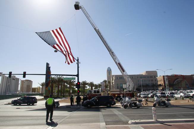 A U.S. flag is flown by the fire department before a memorial service for Metro officer Alyn Beck Saturday, June 14, 2014 at the Smith Center.