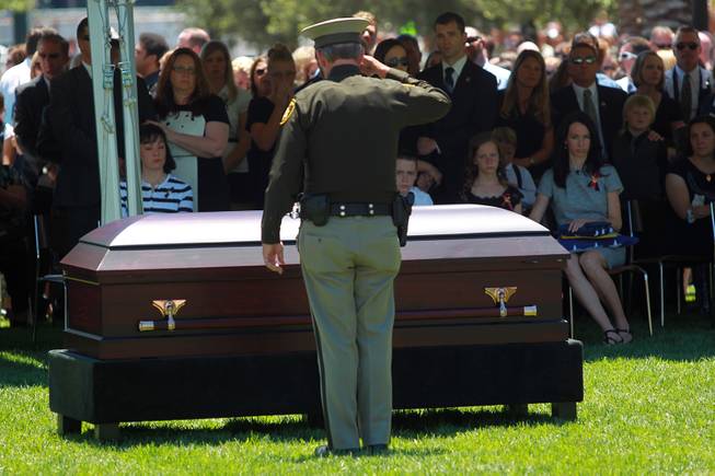 Sheriff Doug Gillespie salutes the casket Metro officer Alyn Beck during a memorial service Saturday, June 14, 2014 at the Smith Center for the Performing Arts.