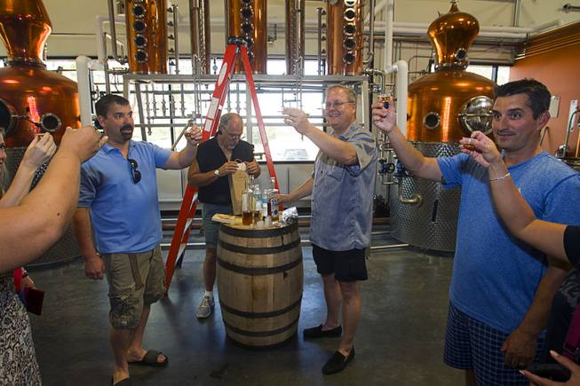 Guests toast with samples of Nevada 150" bourbon whiskey during "Bourbon Day" at the Las Vegas Distillery in Henderson Saturday, June 14, 2014. The "bourbon, the first bourbon produced in Nevada, is named for Nevada's sesquicentennial.