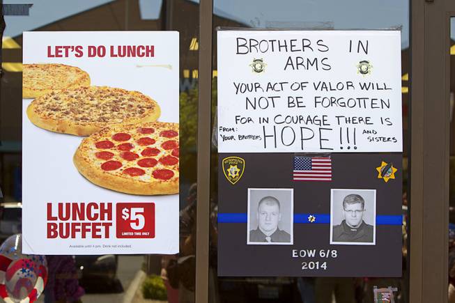 Photos of Metro Police Officers Igor Soldo, left, and Alyn Beck are shown at a memorial during "Sharing Our Support," a fundraiser for the officer's families, at CiCi's Pizza Sunday, June 15, 2014. The officers were ambushed and killed at the restaurant while eating lunch on Sunday, June 8. One hundred percent of the Sunday sales will go the families of the fallen officers and Joseph Willcox, the victim killed at the Wal-Mart, said store owner Mike Haskins.