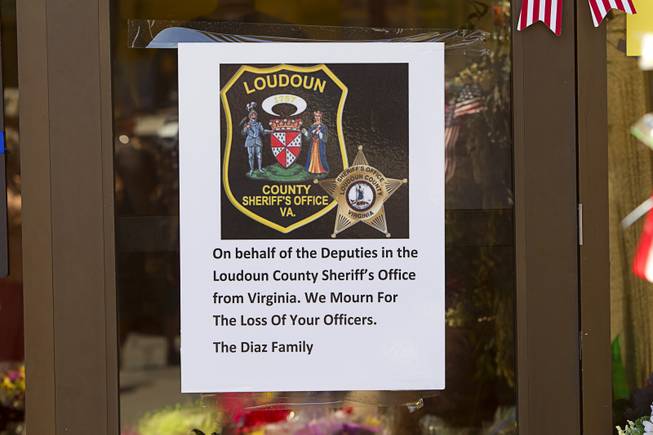 A sign from the Loudoun County Sheriff's office in Virginia is posted at a memorial during "Sharing Our Support," a fundraiser for the families of Metro Police Officers Igor Soldo and Alyn Beck, at CiCi's Pizza Sunday, June 15, 2014. The officers were ambushed and killed at the restaurant while eating lunch on Sunday, June 8. One hundred percent of the Sunday sales will go the families of the fallen officers and Joseph Willcox, the victim killed at the Wal-Mart, said store owner Mike Haskins.