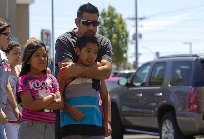 Ricardo Vazquez and his children Mireya, left, and Richardo Jr., look over a memorial during "Sharing Our Support," a fundraiser for the families of Metro Police Officers Igor Soldo and Alyn Beck, at CiCi's Pizza Sunday, June 15, 2014. The officers were ambushed and killed at the restaurant while eating lunch on Sunday, June 8. One hundred percent of the Sunday sales will go the families of the fallen officers and Joseph Willcox, the victim killed at the Wal-Mart, said store owner Mike Haskins.