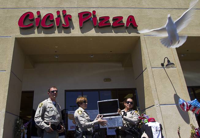 Metro Police officers Ion Iliescu, Lourdes Smith and  Michelle Wilson release the second of two white doves during "Sharing Our Support," a fundraiser for the families of Metro Police Officers Igor Soldo and Alyn Beck, at CiCi's Pizza Sunday, June 15, 2014. The officers were ambushed and killed at the restaurant while eating lunch on Sunday, June 8. One hundred percent of the Sunday sales will go the families of the fallen officers and Joseph Willcox, the victim killed at the Wal-Mart, said store owner Mike Haskins.
