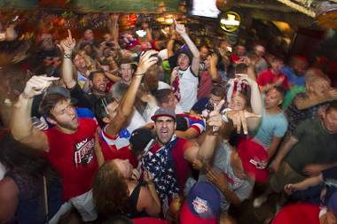 Gershon Levy, center, and other soccer fans celebrate as they watch the United States beat Ghana 2-1 in the World Cup during a viewing party at the Crown & Anchor British Pub Monday, June 16, 2014.