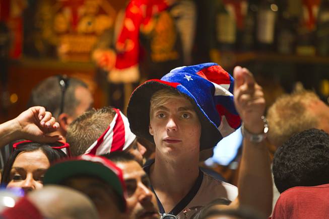 A Soccer fan wears a patriotic hat as he watches the United States play Ghana in the World Cup during a viewing party at the Crown & Anchor British Pub Monday, June 16, 2014.