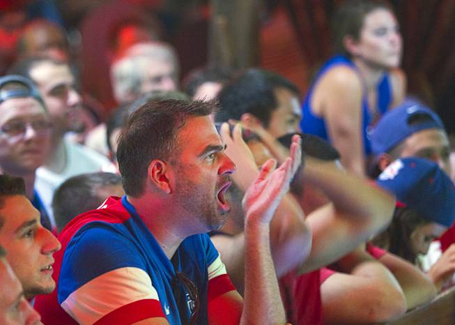Aaron Pelcher calls out as he watches the United States play Ghana 2-1 in the World Cup during a viewing party at the Crown & Anchor British Pub Monday, June 16, 2014.