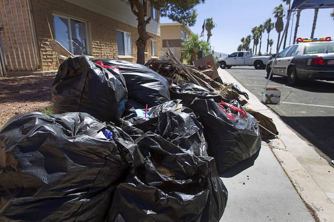 Bags of garbage are shown on Sunrise Avenue during a Downtown Community Coalition neighborhood cleanup near Fremont Street and 21st Street Tuesday, June 17, 2014. An estimated 8 tons of garbage was collected during the event, said Metro Police Officer Aden Ocampo-Gomez. A bobcat from the city's rapid response unit picked up the larger items such as an abandoned couch and discarded mattresses, he said.