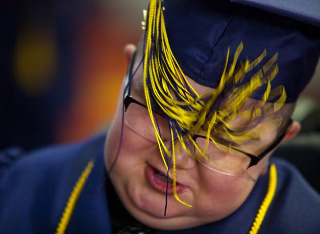 Colton Shrum has his tassel accidentally tangled in his glasses before his graduation ceremony for the Odyssey Charter School at the Cashman Center on Tuesday, June, 3, 2014.