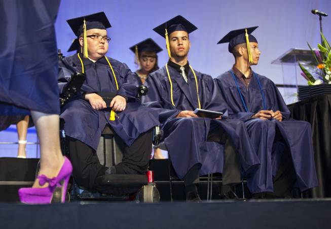 Colton Shrum, D'Aron Martin and Darius Martin sit patiently with other students during the Cashman Center  for their Odyssey Charter School graduation on Tuesday, June, 3, 2014.