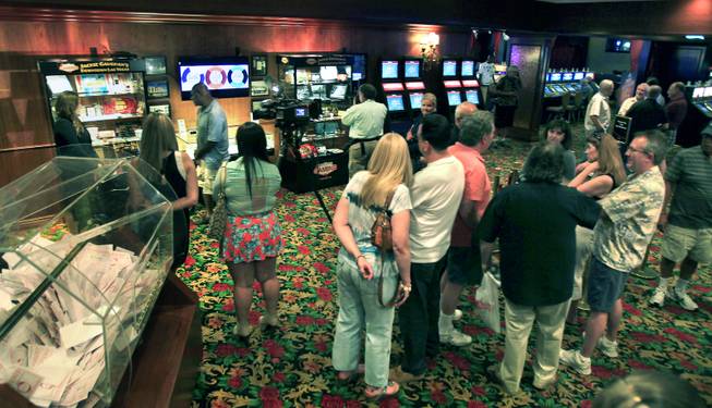 Attendees gather to premier the El Cortez Hotel & Casino and the Museum of Gaming History honoring of downtown gaming legend Jackie Gaughan with the unveiling of a memorial exhibit titled Jackie Gaughans Downtown as seen through Gaming Memorabilia" on Tuesday, June 17, 2014.