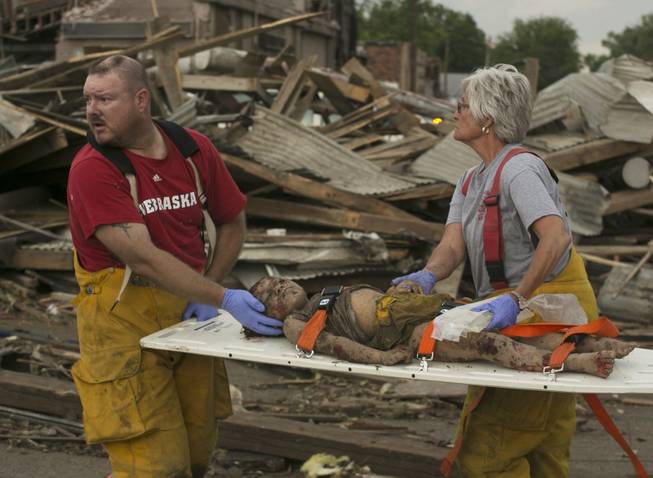 Rescue personnel tend to a young tornado victim in  Pilger, Neb., Monday, June 16, 2014. A hospital spokeswoman says at least one person is dead and at least 16 more are in critical condition after two massive tornadoes swept through northeast Nebraska.