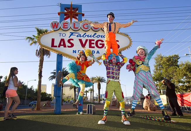 Ringling Bros. and Barnum & Bailey Circus clowns pose in front of the Welcome to Fabulous Las Vegas sign Wednesday, June 18, 2014. The circus performs at Thomas & Mack Center Thursday through Sunday.