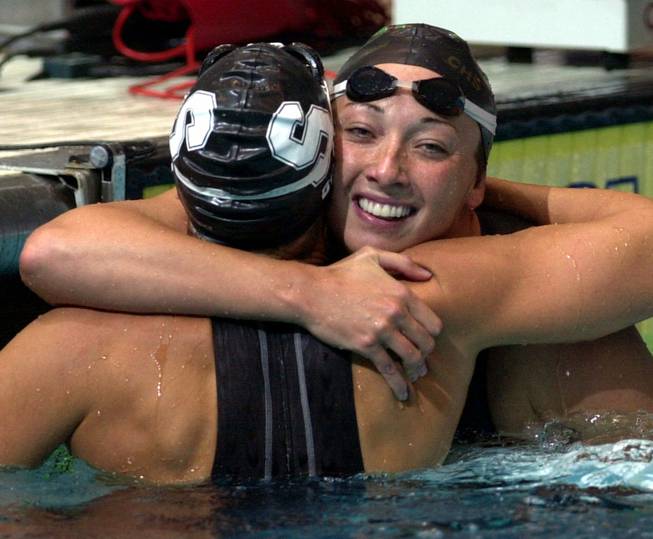 In this Aug. 16, 2000, file photo, Amy Van Dyken, right, of Lone Tree, Colo., hugs Dara Torres of Palo Alto, Calif., after Torres won the finals of the women's 50-meter freestyle at the U.S. Olympic Swimming Trials in Indianapolis.