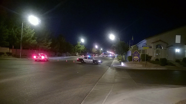Lindell Road is closed down while Metro Police officers tend to a standoff near Hacienda Avenue, Wednesday, June 18, 2014.
