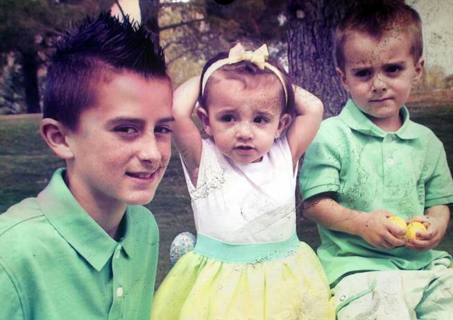 An undated photo provided by family friend Craig Freudlich shows Ella Flores and Cruz Flores, right. The children died in an early morning fire at the home near Ann Road and Durango Drive Thursday, June 19, 2014. The older brother Ryan, left, was not at the home.