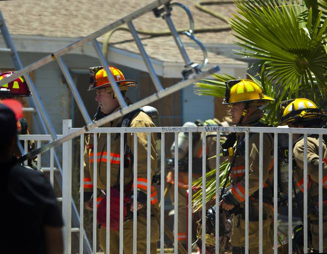 Las Vegas Fire & Rescue work an apartment fire at 1820 East Lewis Ave. which spread to a nearby tree and shed on Thursday, June, 19, 2014.
